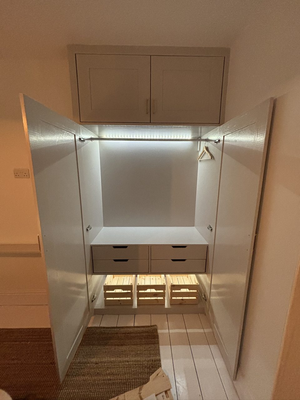 Built-in wardrobe with LED strip light, drawers and an overhead cupboard